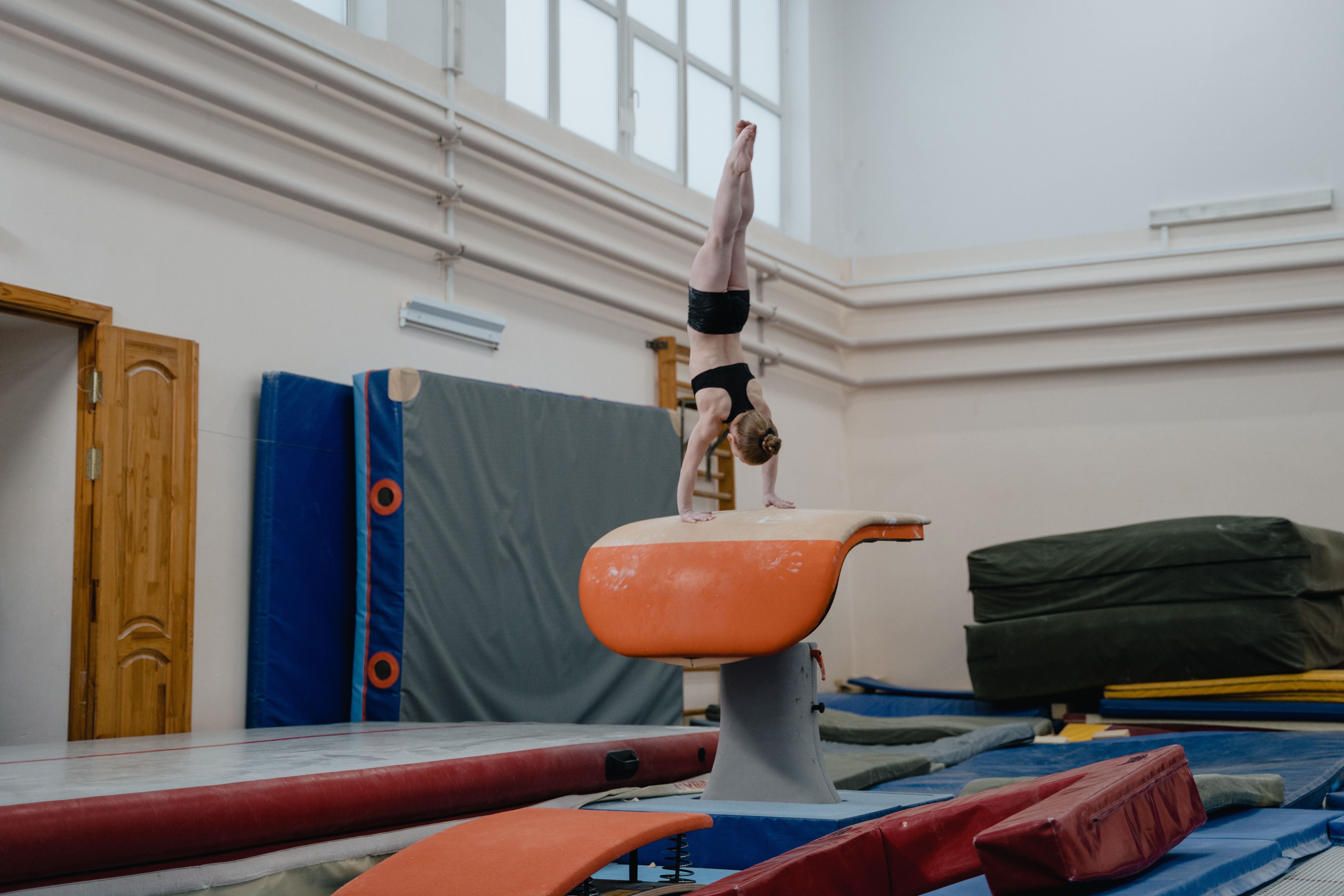 Young gymnast performing on balance beam